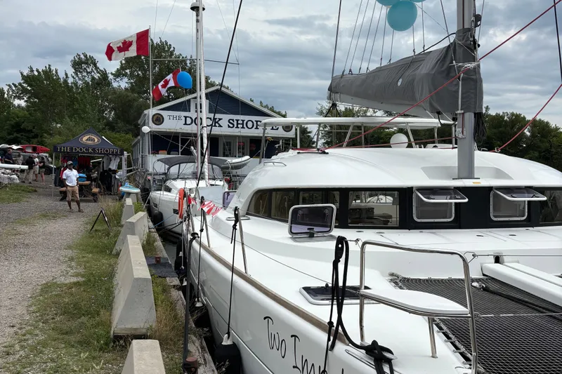 Too Impulsive Yacht Photos Pics 2014 Lagoon 380 S2 catamaran docked near The Dock Shoppe with Canadian flags.