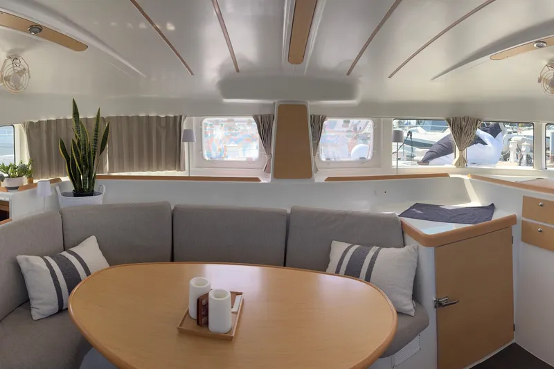 Too Impulsive Yacht Photos Pics Interior of 2014 Lagoon 380 S2 catamaran with cozy seating and modern decor.