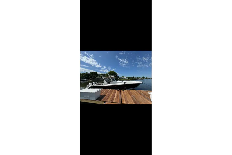  Yacht Photos Pics 2017 Edgewater 368CC boat docked on a sunny day with clear skies.