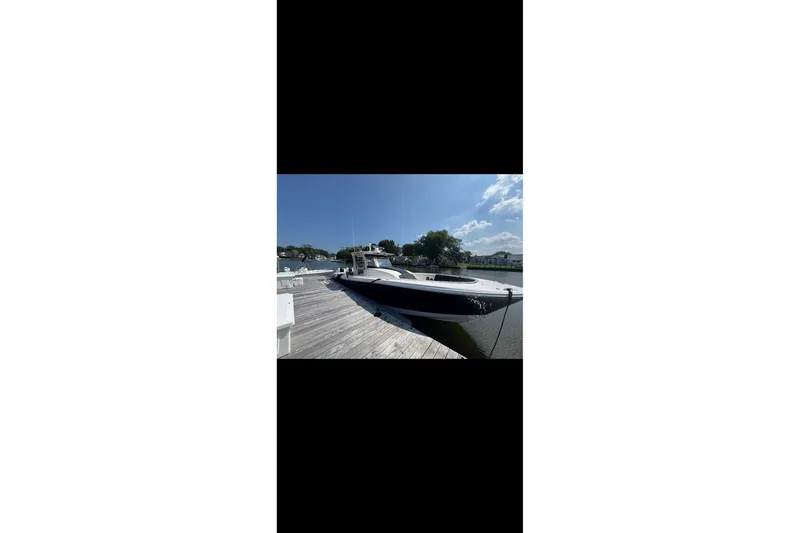  Yacht Photos Pics 2017 Edgewater 368CC boat docked on a sunny day, clear blue sky.