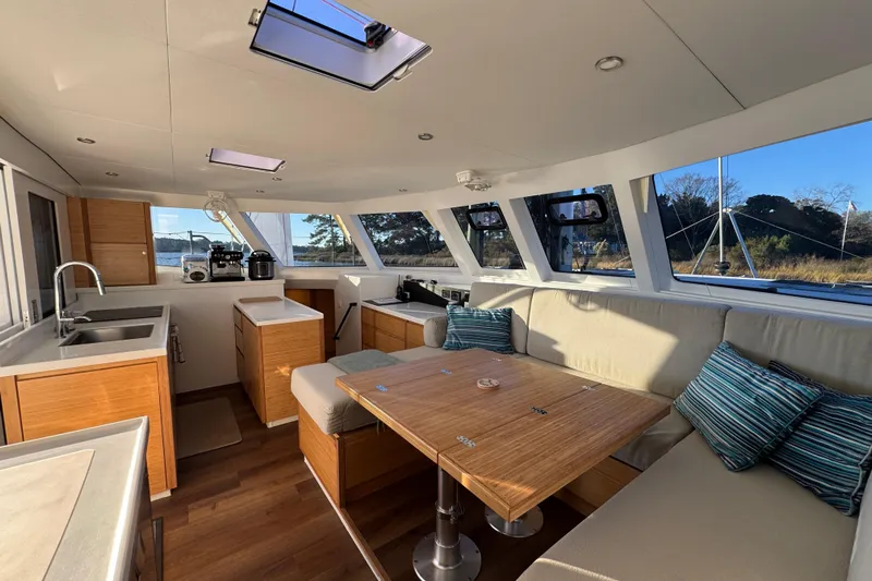 Hokule'a Yacht Photos Pics Luxurious interior of 2024 Balance 482 yacht with modern kitchen and seating area.