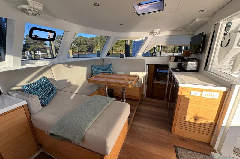 Hokule'a Yacht Photos Pics Luxurious interior of 2024 Balance 482 yacht with modern kitchen and cozy seating area.