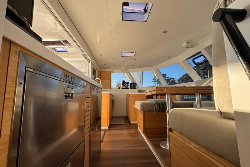 Hokule'a Yacht Photos Pics Luxurious interior of 2024 Balance 482 yacht with modern kitchen and seating area.