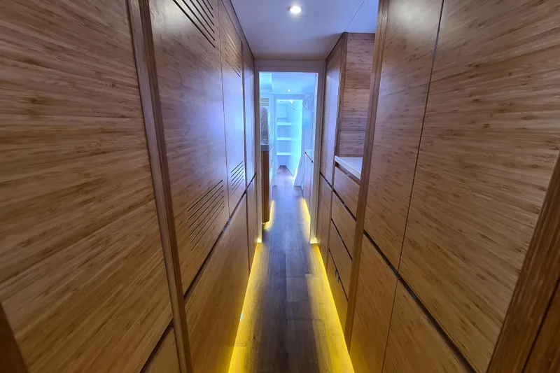 Hokule'a Yacht Photos Pics Narrow hallway with wooden paneling and ambient lighting in Balance 482, 2024 model.