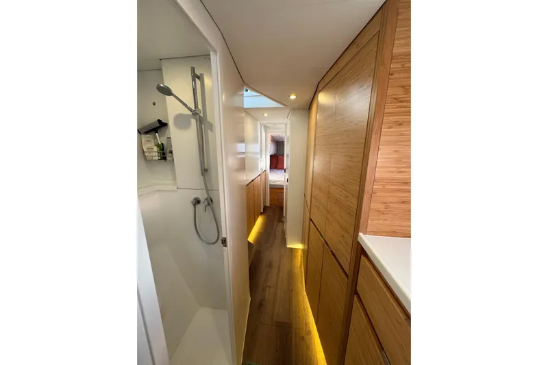 Hokule'a Yacht Photos Pics Modern interior of 2024 Balance 482 yacht with sleek wood paneling and compact shower.