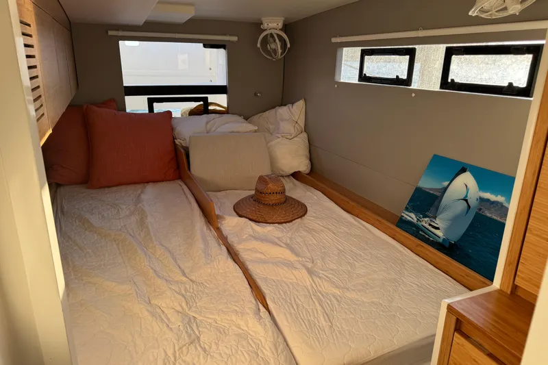 Hokule'a Yacht Photos Pics Cozy cabin interior of 2024 Balance 482 yacht with bed, pillows, and sailing photo.