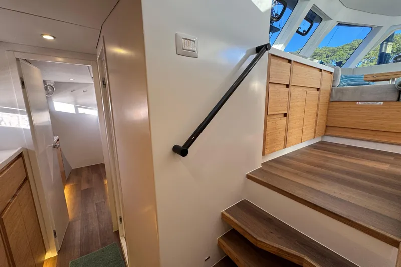 Hokule'a Yacht Photos Pics Modern interior of 2024 Balance 482 yacht with wooden stairs and sleek design.