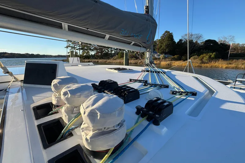 Hokule'a Yacht Photos Pics Sailboat deck of 2024 Balance 482, featuring rigging and winches, docked by a scenic shoreline.