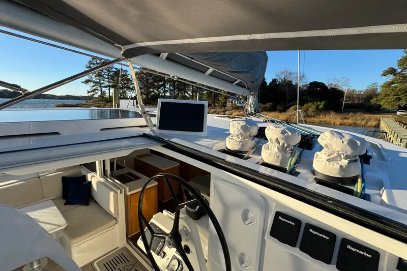 Hokule'a Yacht Photos Pics 2024 Balance 482 yacht cockpit with steering wheel, navigation equipment, and scenic waterfront view.