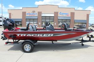 2025 Tracker Pro Team 175 boat in red, parked outside a dealership.
