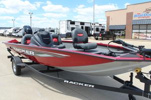 2025 Tracker Pro Team 175 boat, red and gray, parked outside dealership.