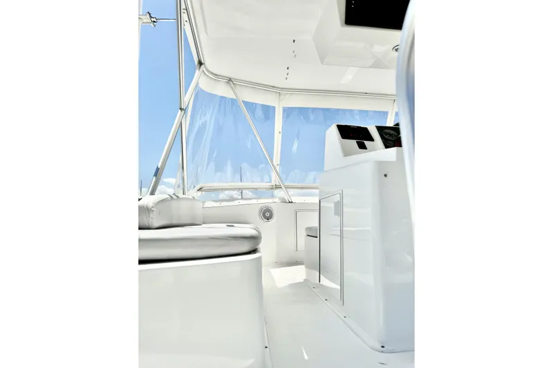 Marlin Magic Yacht Photos Pics Interior view of 1999 Viking 43 Convertible yacht, featuring sleek white design and modern controls.