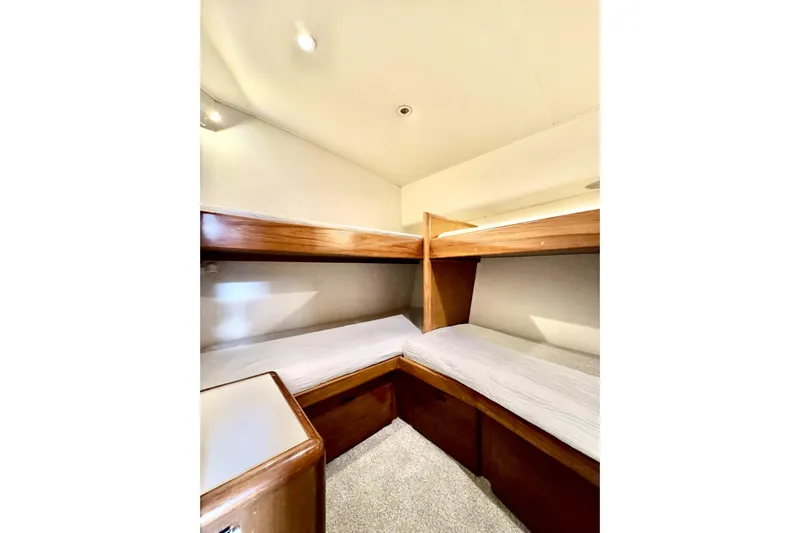 Marlin Magic Yacht Photos Pics 1999 Viking 43 Convertible yacht interior with cozy bunk beds and wooden accents.