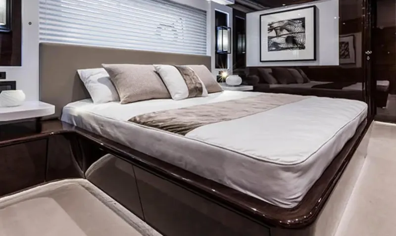  Yacht Photos Pics Luxurious bedroom interior of 2025 Pearl 95 yacht with modern decor and elegant bedding.