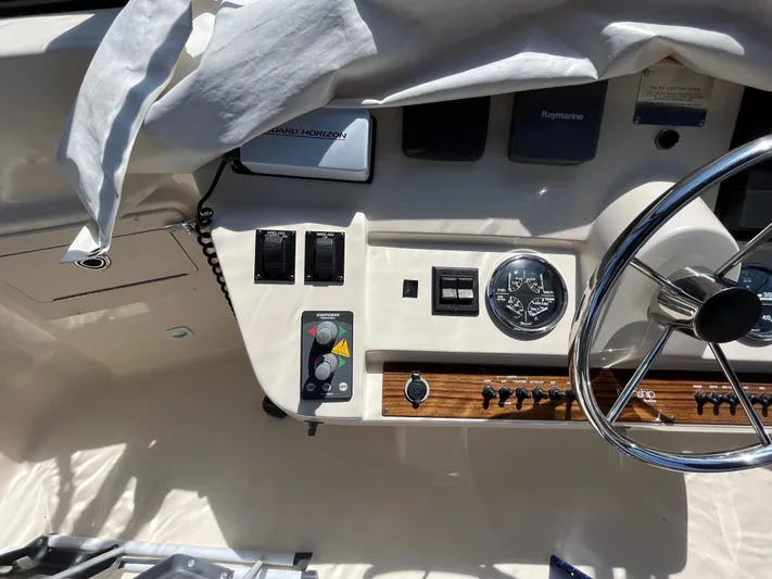  Yacht Photos Pics 2005 Mainship 400 Trawler helm with steering wheel and control panel.