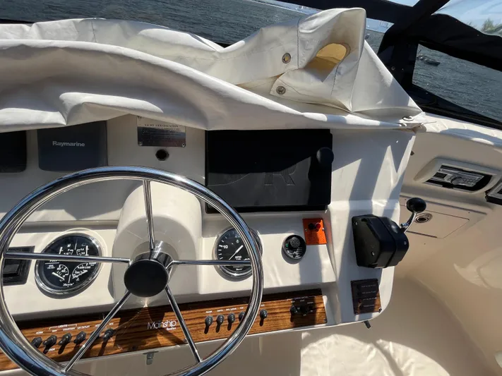  Yacht Photos Pics 2005 Mainship 400 Trawler helm with steering wheel, gauges, and navigation equipment.