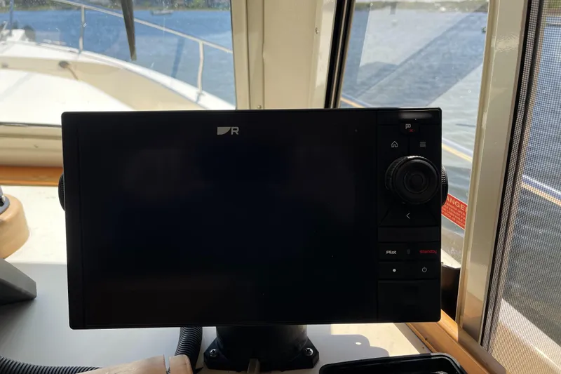  Yacht Photos Pics Navigation system on 2005 Mainship 400 Trawler, with water view through window.