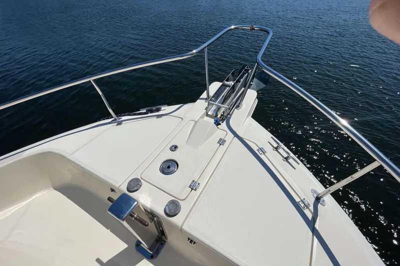  Yacht Photos Pics 2005 Mainship 400 Trawler bow with stainless steel railings on calm water.