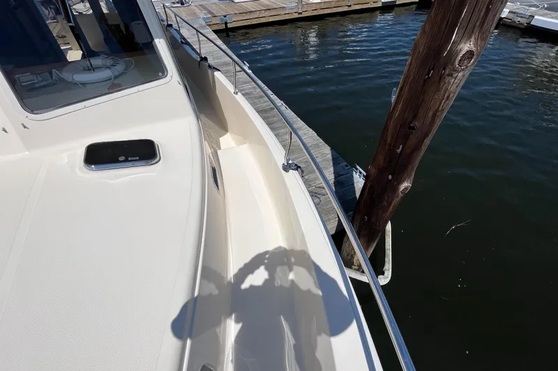  Yacht Photos Pics 2005 Mainship 400 Trawler docked, showing deck and railing details.