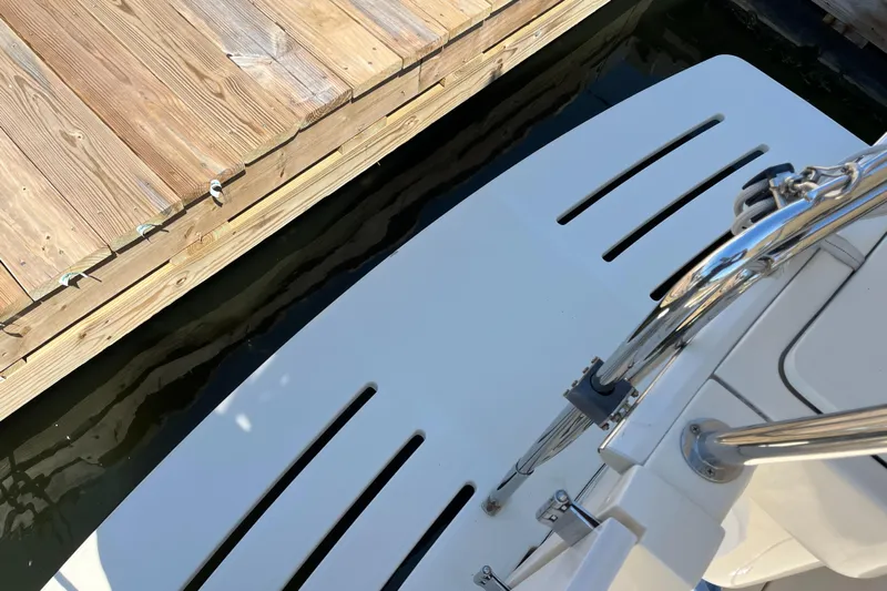  Yacht Photos Pics 2005 Mainship 400 Trawler docked, showing swim platform and wooden pier.