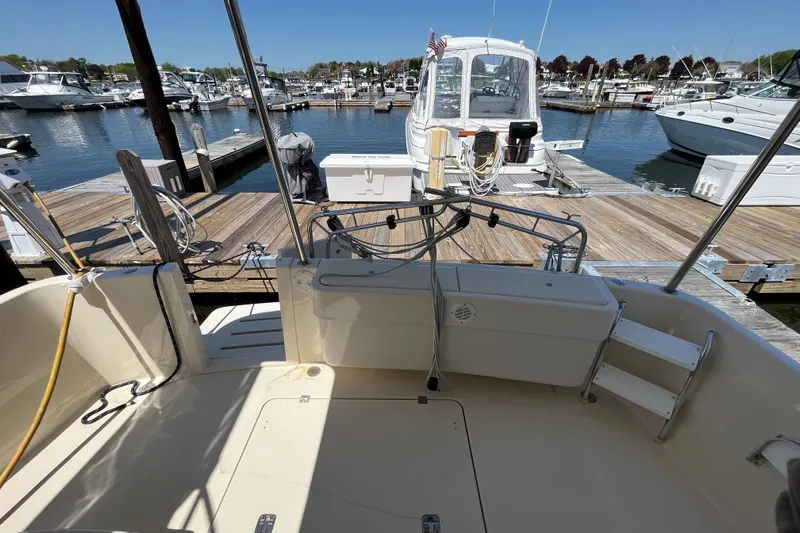  Yacht Photos Pics 2005 Mainship 400 Trawler docked at marina, showcasing spacious deck and nearby boats.