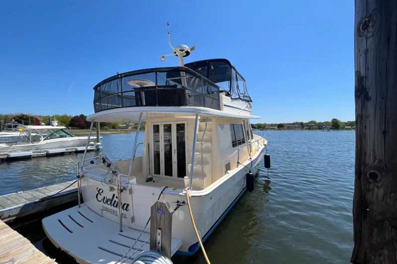  Yacht Photos Pics 2005 Mainship 400 Trawler docked on a sunny day, rear view.