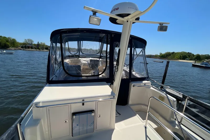  Yacht Photos Pics 2005 Mainship 400 Trawler on water, featuring spacious deck and enclosed cockpit.