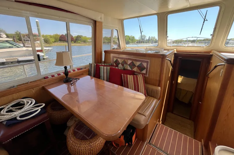  Yacht Photos Pics Interior of 2005 Mainship 400 Trawler with dining area and waterfront view.
