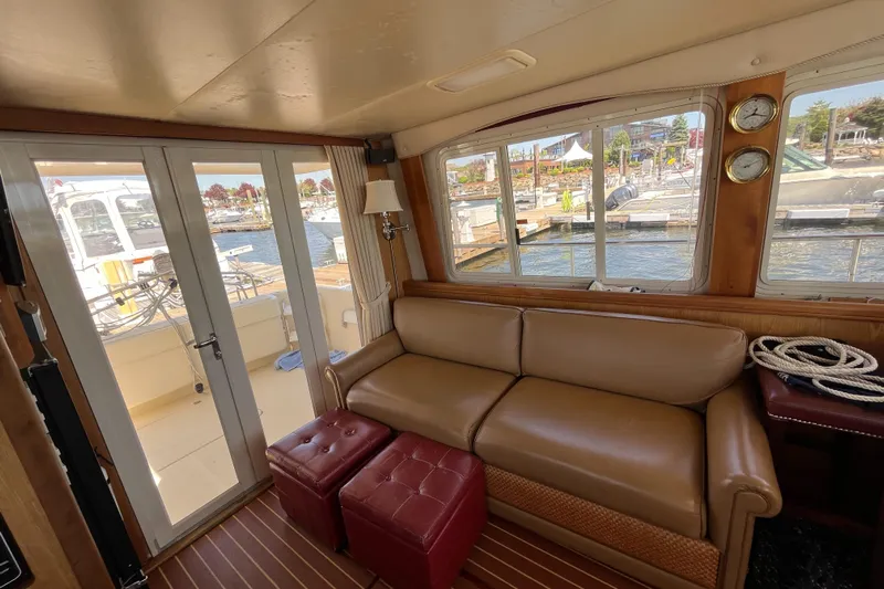 Yacht Photos Pics Interior of 2005 Mainship 400 Trawler with leather sofa and marina view.