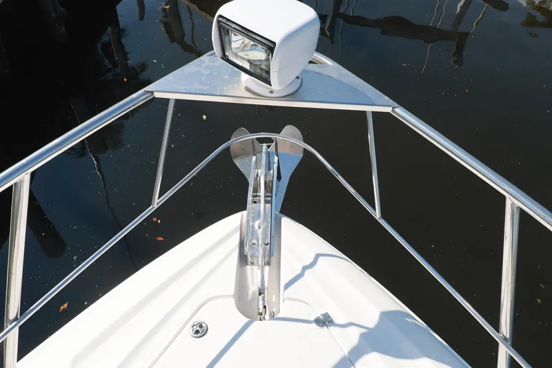 Nauti Buoy Yacht Photos Pics Bow view of 2007 Cruisers 520 Express yacht with anchor and spotlight.