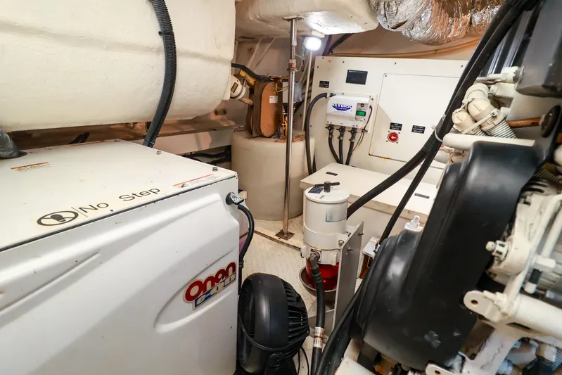 Nauti Buoy Yacht Photos Pics Engine room of 2007 Cruisers 520 Express yacht with Onan generator and mechanical components.