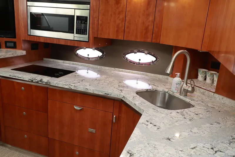 Nauti Buoy Yacht Photos Pics Luxurious 2007 Cruisers 520 Express yacht kitchen with modern appliances and elegant wood cabinetry.