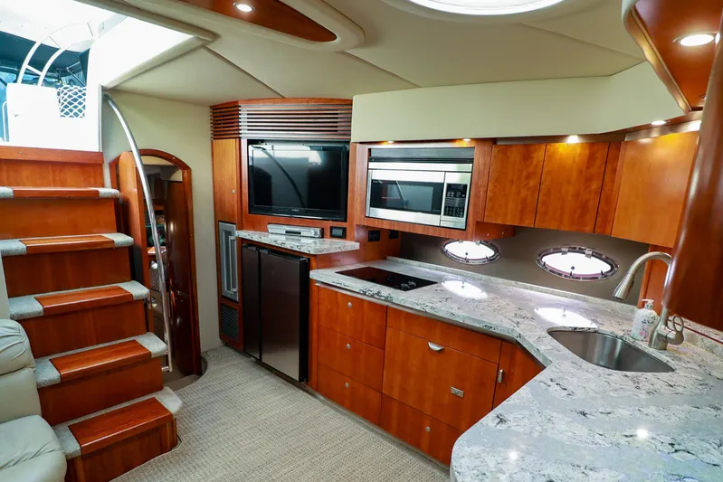 Nauti Buoy Yacht Photos Pics Luxurious 2007 Cruisers 520 Express yacht interior with modern kitchen and elegant wood finishes.