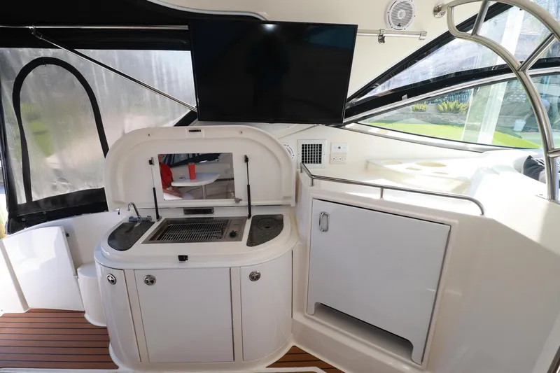 Nauti Buoy Yacht Photos Pics 2007 Cruisers 520 Express yacht interior with kitchenette and TV setup.