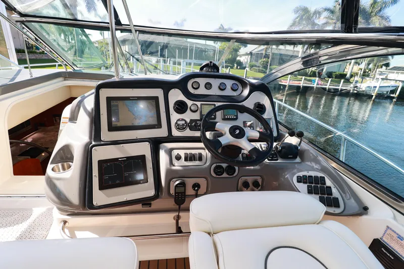Nauti Buoy Yacht Photos Pics 2007 Cruisers 520 Express yacht helm with navigation controls and waterfront view.