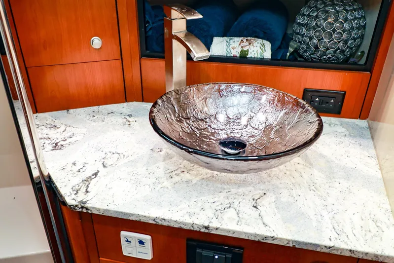 Nauti Buoy Yacht Photos Pics Luxurious glass sink on marble countertop in 2007 Cruisers 520 Express yacht bathroom.