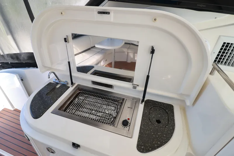 Nauti Buoy Yacht Photos Pics 2007 Cruisers 520 Express yacht outdoor kitchen with grill and sink.