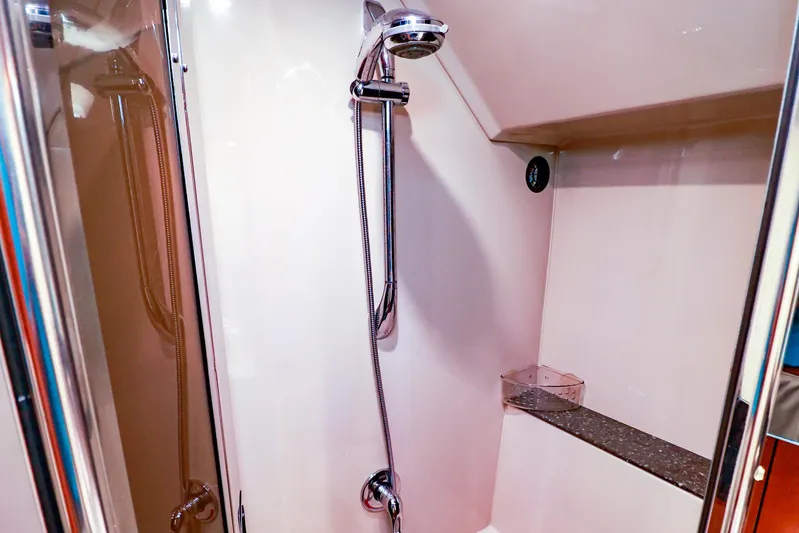 Nauti Buoy Yacht Photos Pics Shower area in 2007 Cruisers 520 Express yacht, featuring modern fixtures and storage shelf.