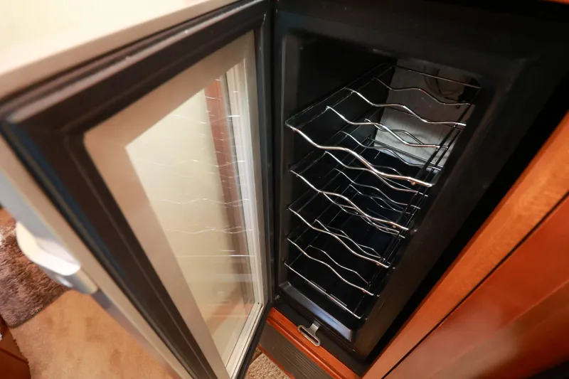 Nauti Buoy Yacht Photos Pics Open wine cooler with metal racks inside a 2007 Cruisers 520 Express yacht.