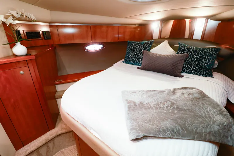 Nauti Buoy Yacht Photos Pics Luxurious cabin interior of 2007 Cruisers 520 Express yacht with elegant bedding and wood finish.