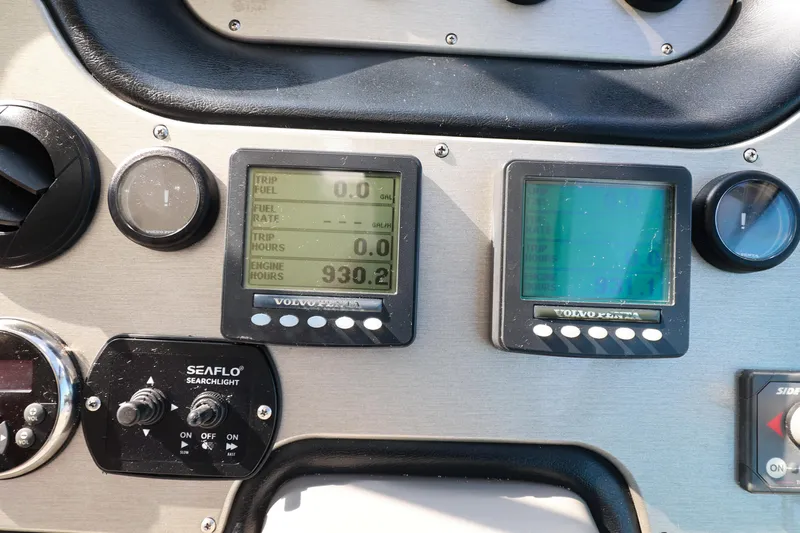 Nauti Buoy Yacht Photos Pics Dashboard of 2007 Cruisers 520 Express with Volvo Penta displays and Seaflo searchlight controls.