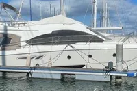 2008 Intermare 50 Fly Bridge yacht docked at marina under blue sky.