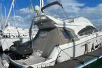 Luxury 2008 Intermare 50 Fly Bridge yacht docked at marina under blue sky.