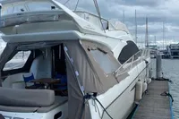 2008 Intermare 50 Fly Bridge yacht docked at marina under cloudy skies.