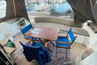 2008 Intermare 50 Fly Bridge yacht interior with seating, table, and marina view.