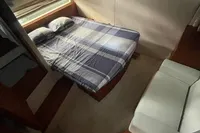 2008 Intermare 50 Fly Bridge cabin with bed, sofa, and porthole window.