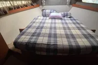 2008 Intermare 50 Fly Bridge cabin with plaid bedding and wooden accents.