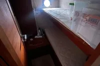2008 Intermare 50 Fly Bridge cabin interior with bunk beds and porthole.