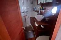 2008 Intermare 50 Fly Bridge yacht bathroom with shower, sink, and wooden accents.