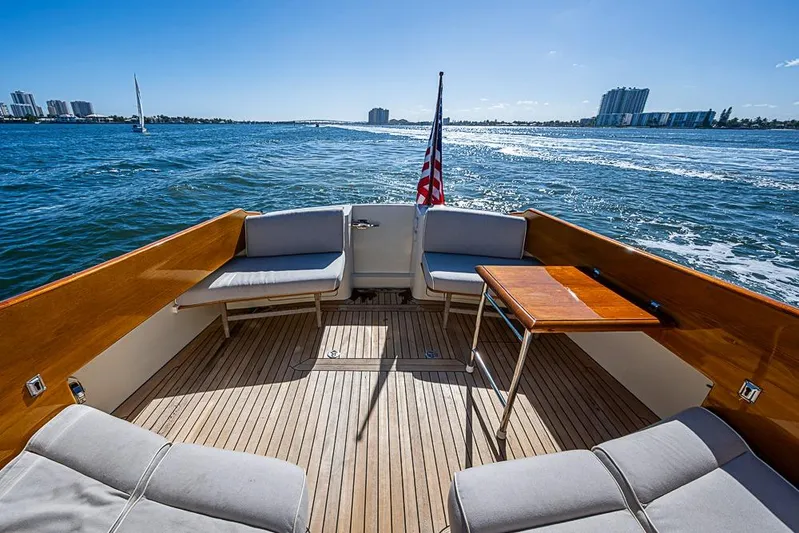 Skylark Yacht Photos Pics Hinckley Talaria 44 MY 2008 yacht deck with seating, table, and ocean view.